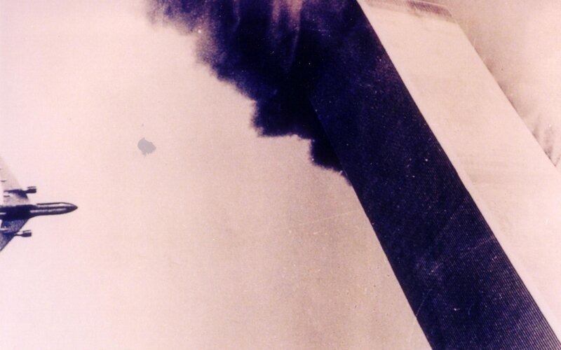 Airplane flying near smoke