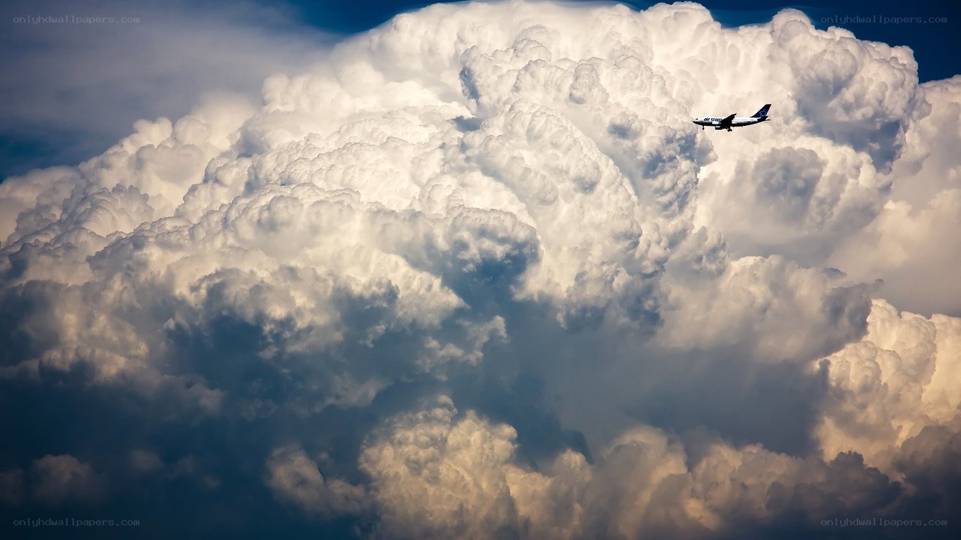 Airplane flying near storm cloud
