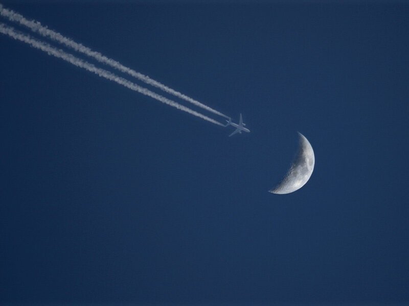 Airplane flying near the moon