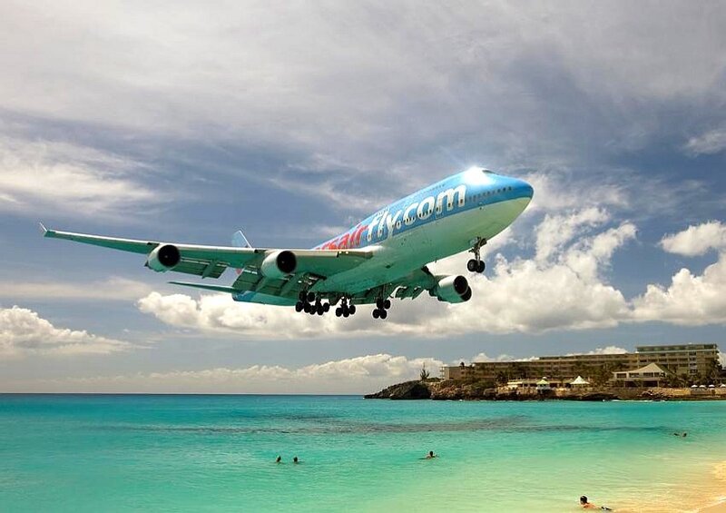 Airplane flying over beach