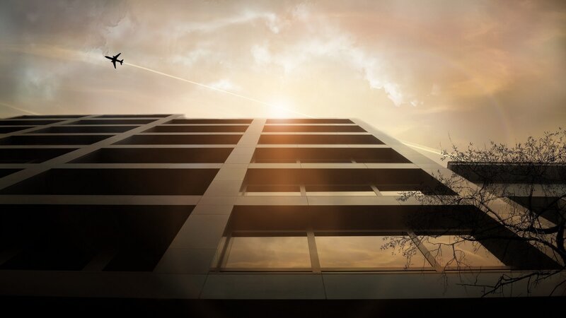 Airplane Flying over Building