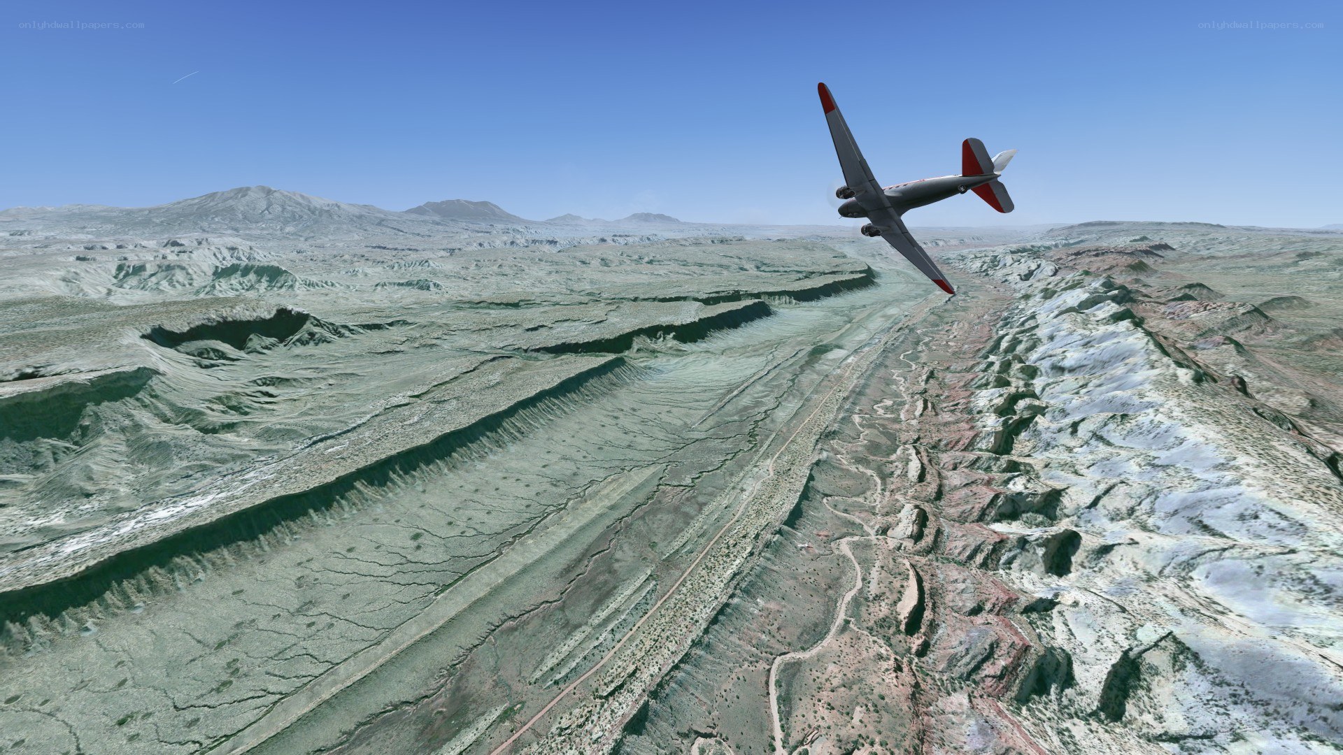 airplane flying over canyon