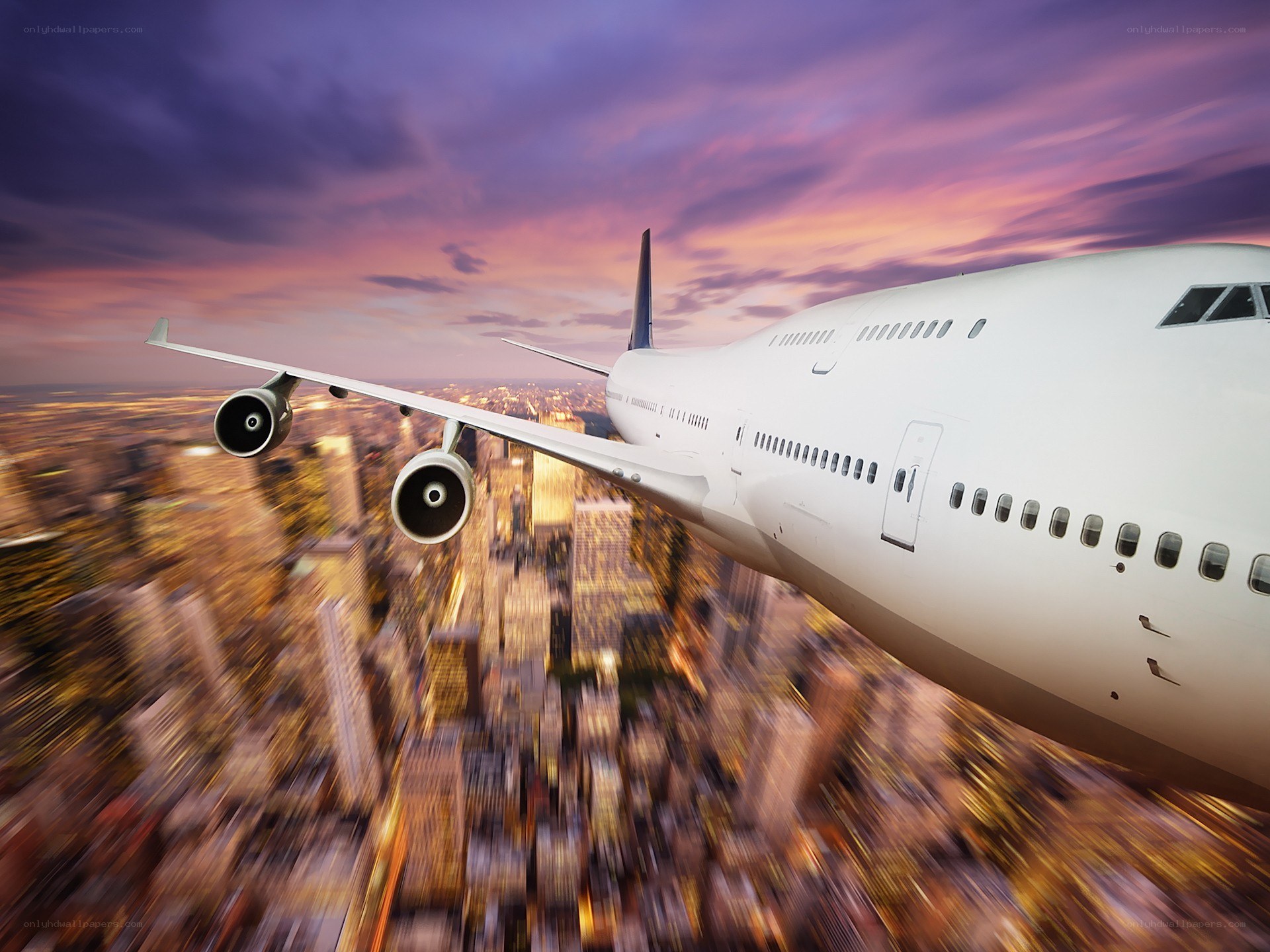 Airplane flying over city at sunset