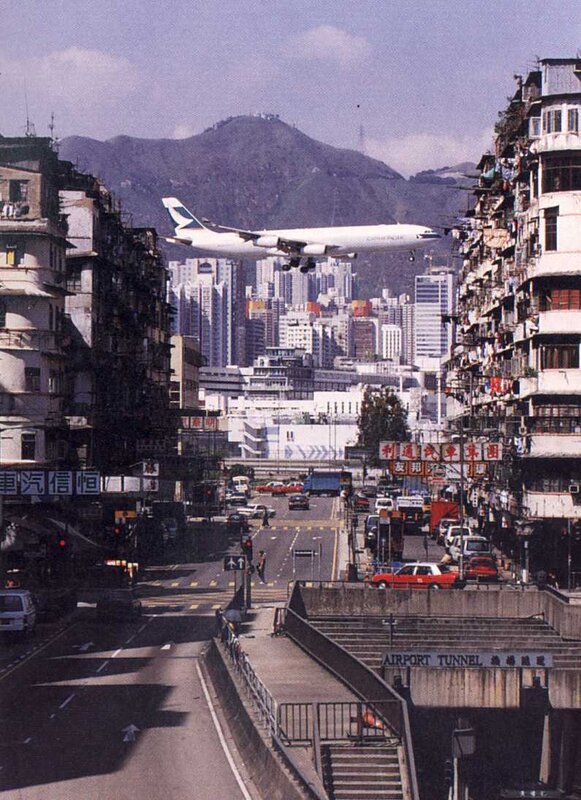 Airplane flying over city street
