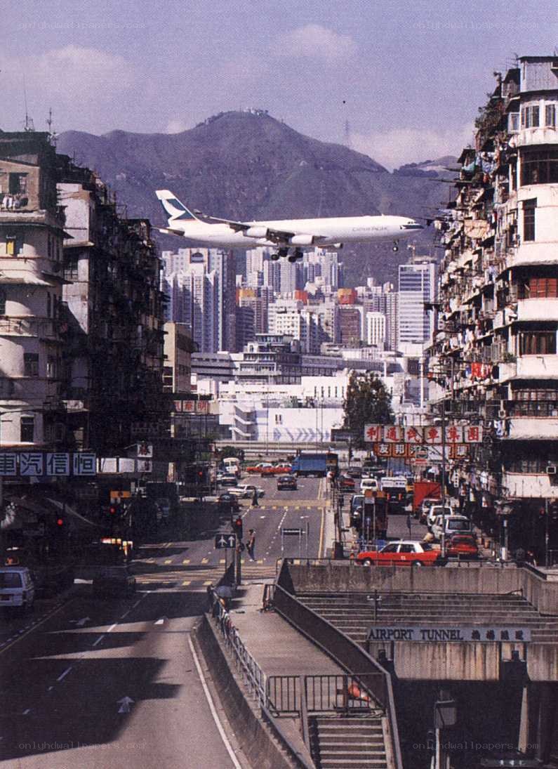 Airplane flying over city street