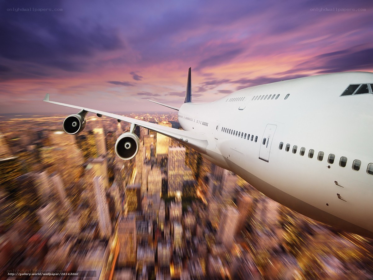 Airplane flying over city