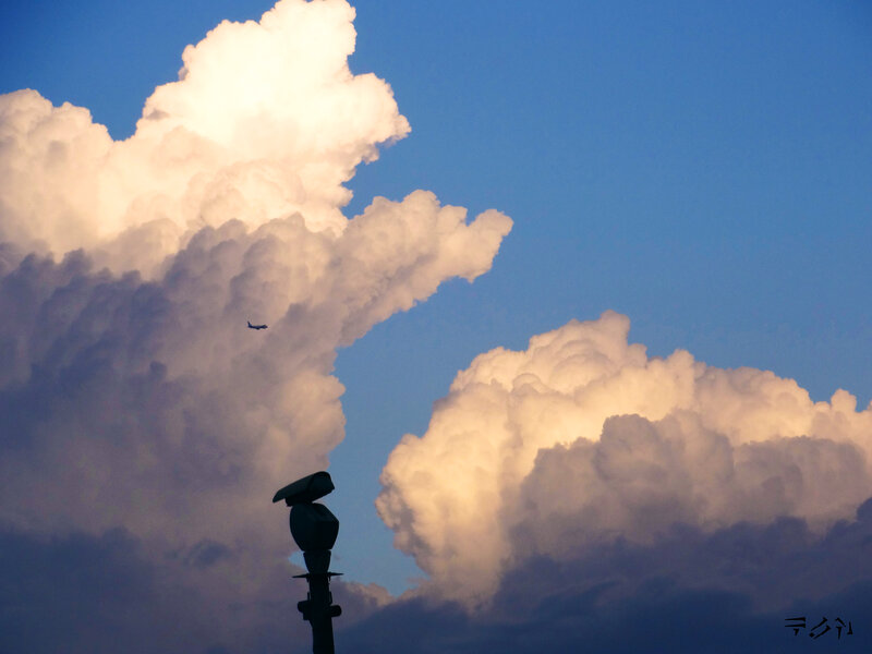 Airplane Flying over Clouds — Blue
