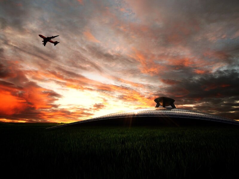 Airplane flying over dome at sunset