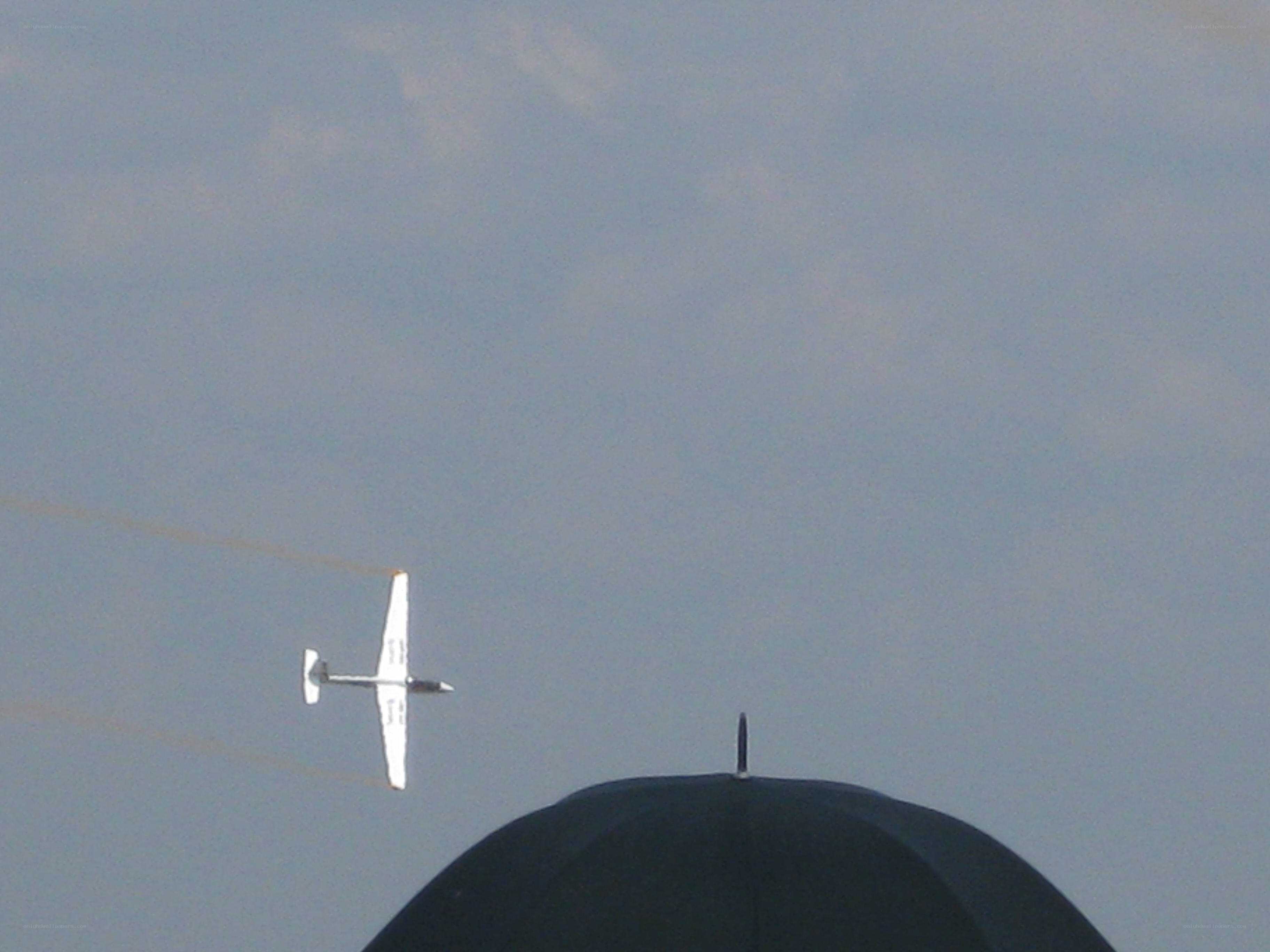 airplane flying over dome