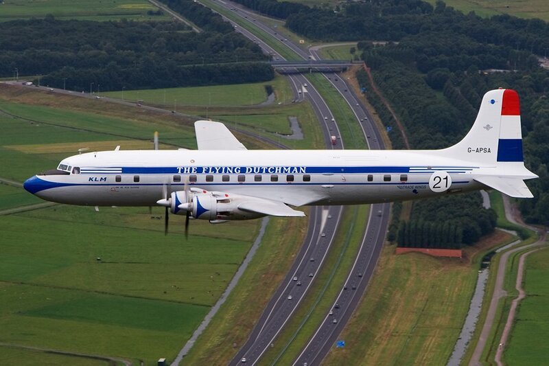Airplane Flying over Highway — White