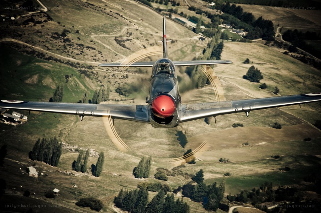 airplane flying over hills