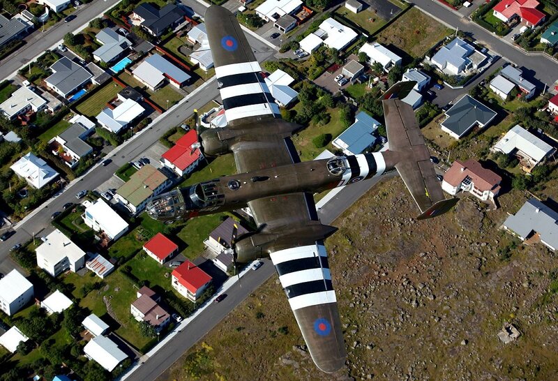Airplane Flying over Houses