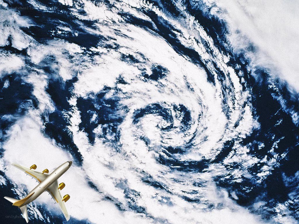 airplane flying over hurricane