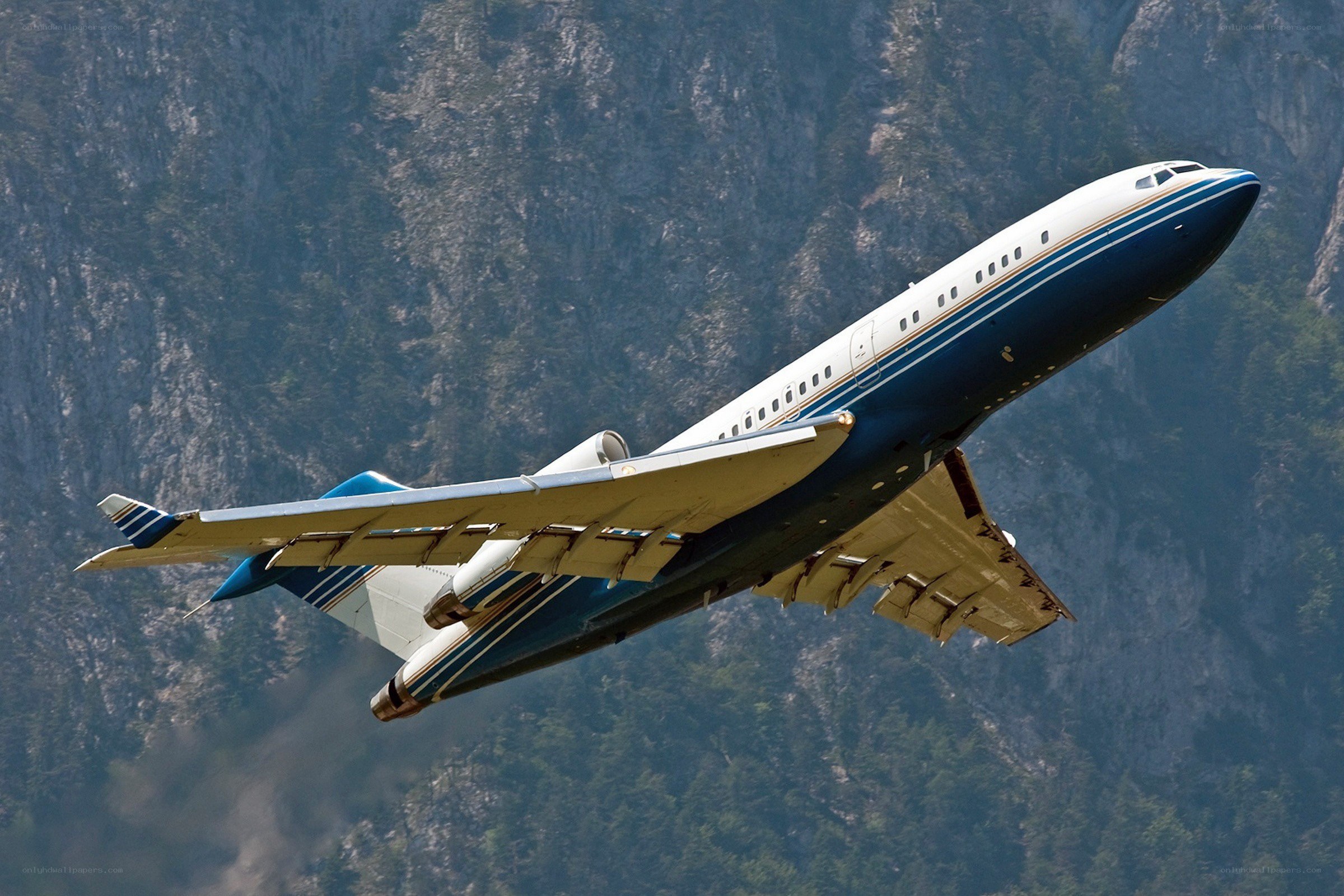 airplane flying over mountains