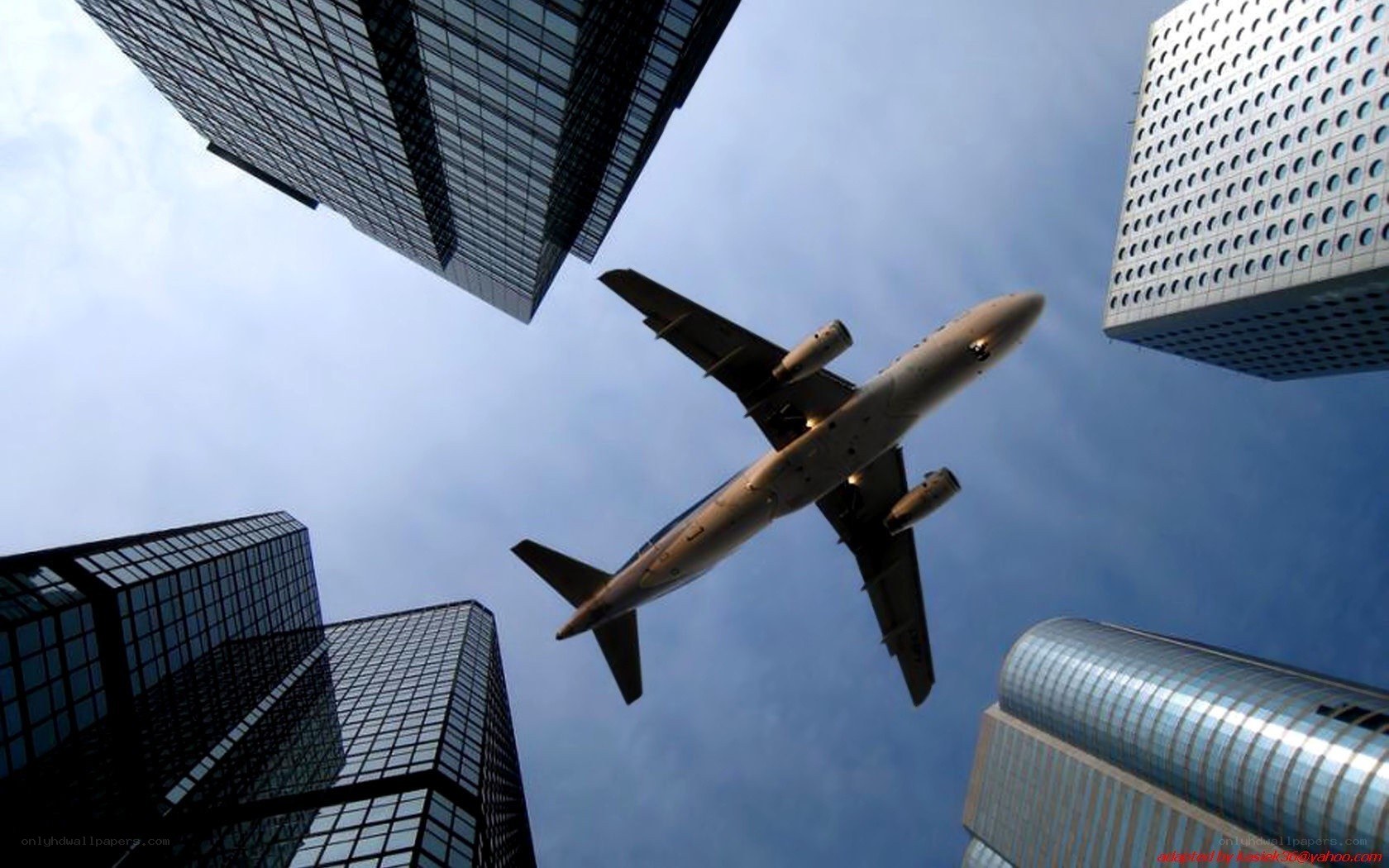 airplane flying over skyscrapers