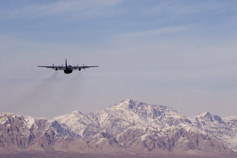 Airplane flying over snowy mountains