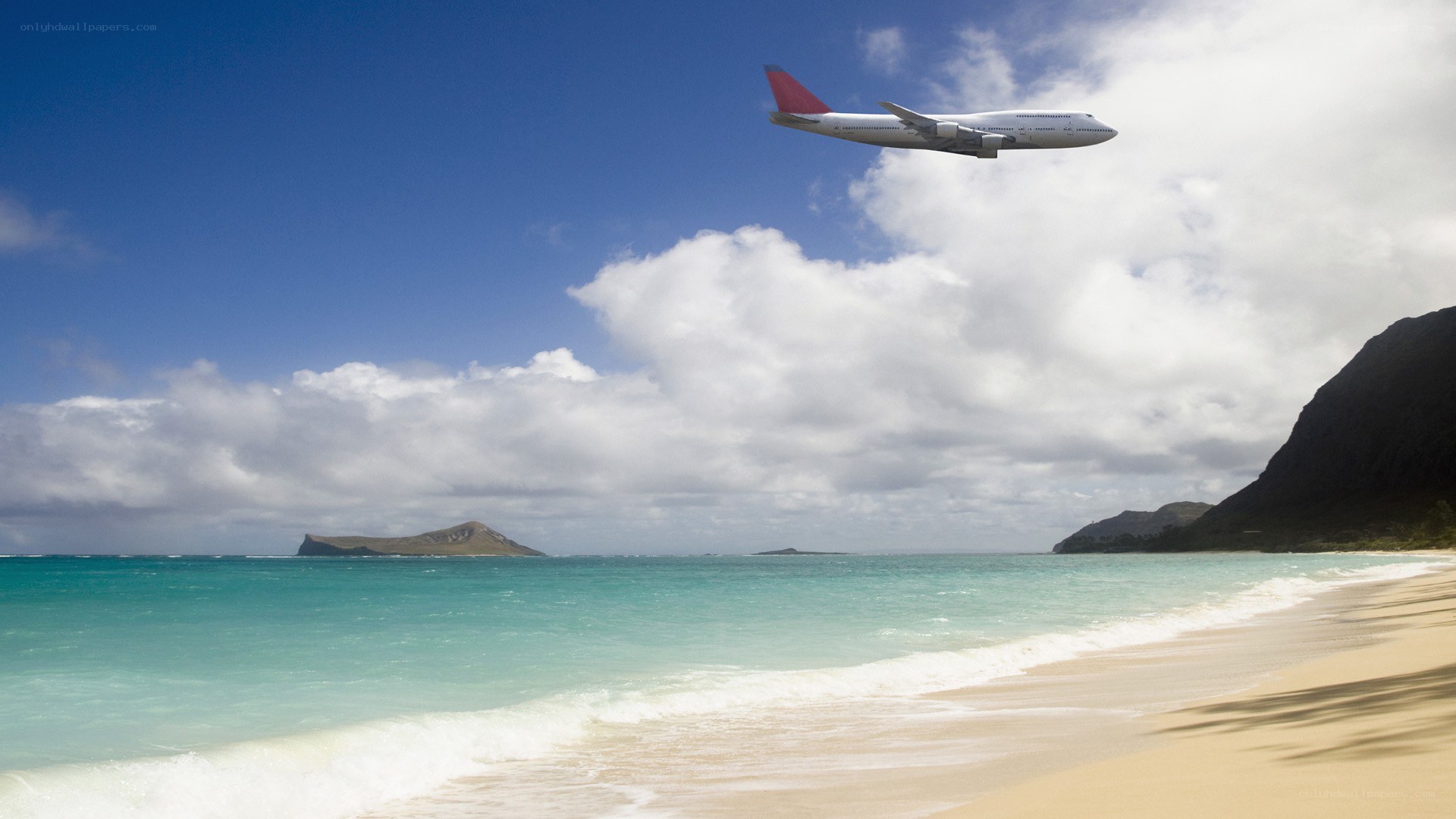 Airplane flying over tropical beach