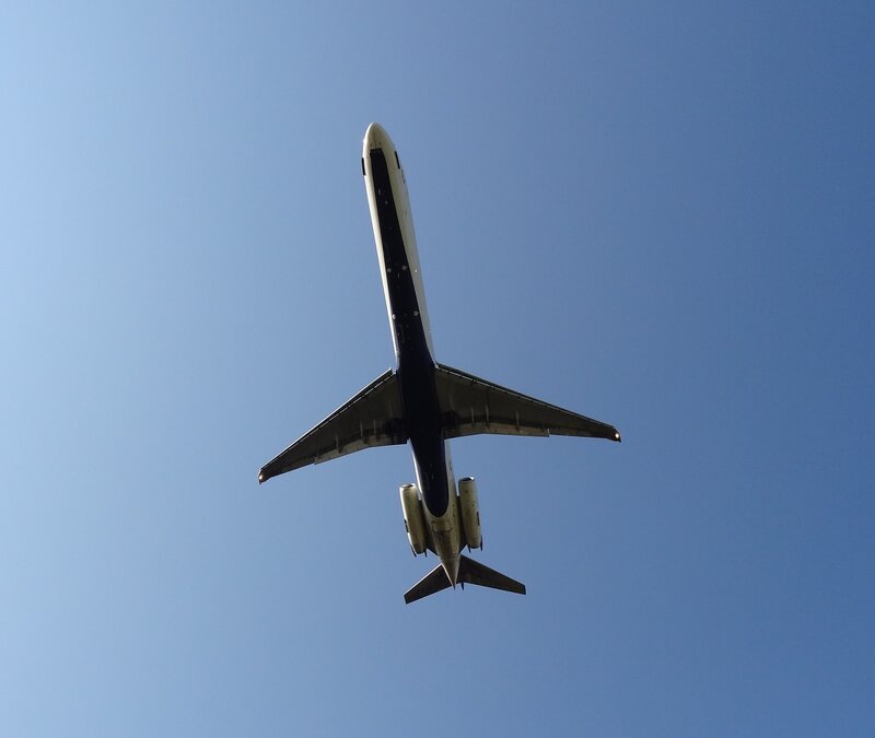 Airplane Flying Overhead — Blue, Serene, Afternoon