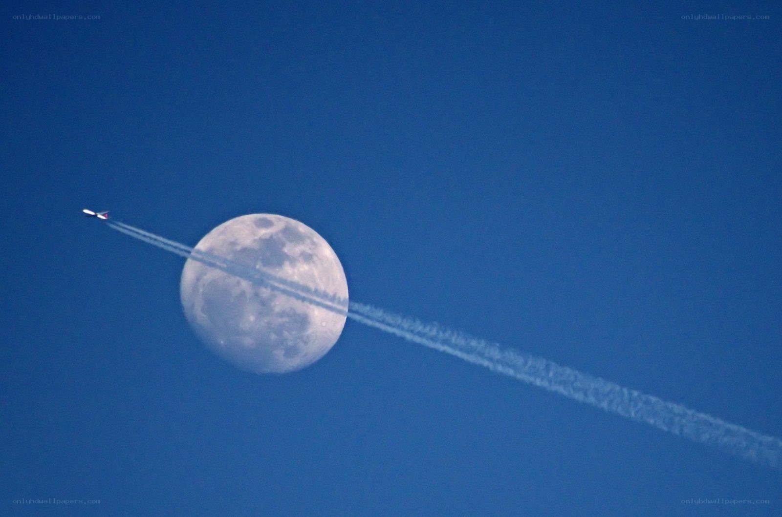 Airplane flying past the moon