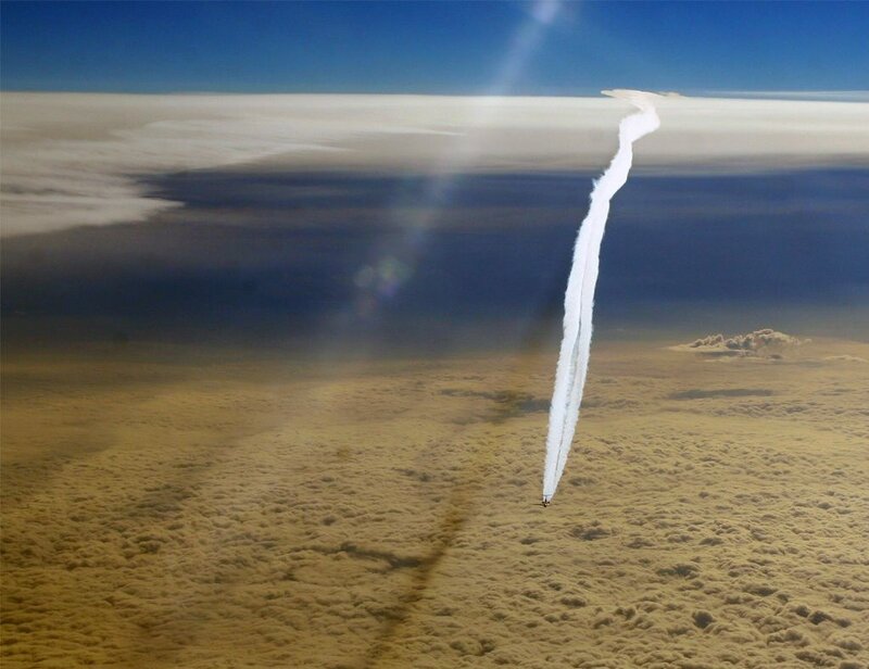 Airplane Flying Through Clouds — Blue