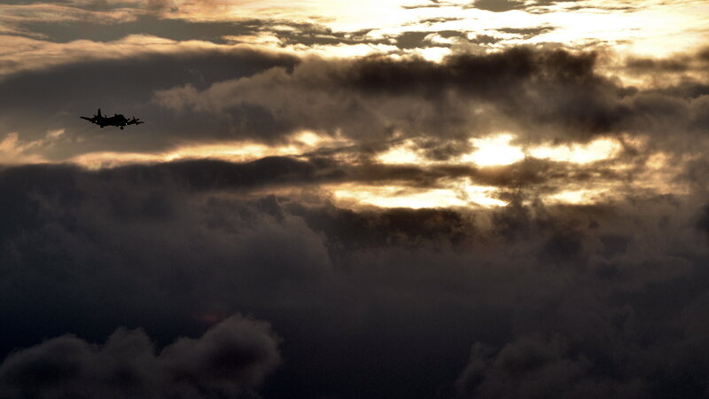 Airplane Flying Through Clouds — Gray