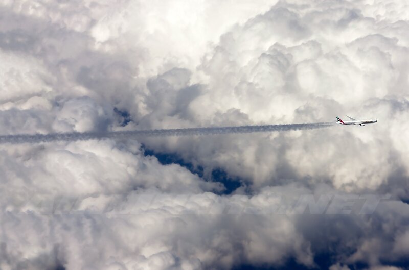 Airplane Flying Through Clouds — White