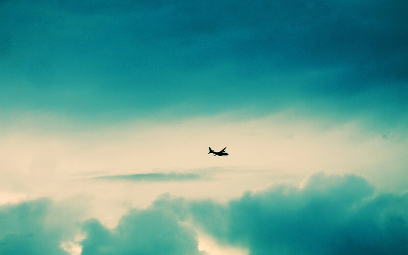 Airplane flying through cloudy sky