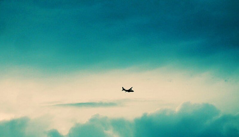 Airplane flying through cloudy sky