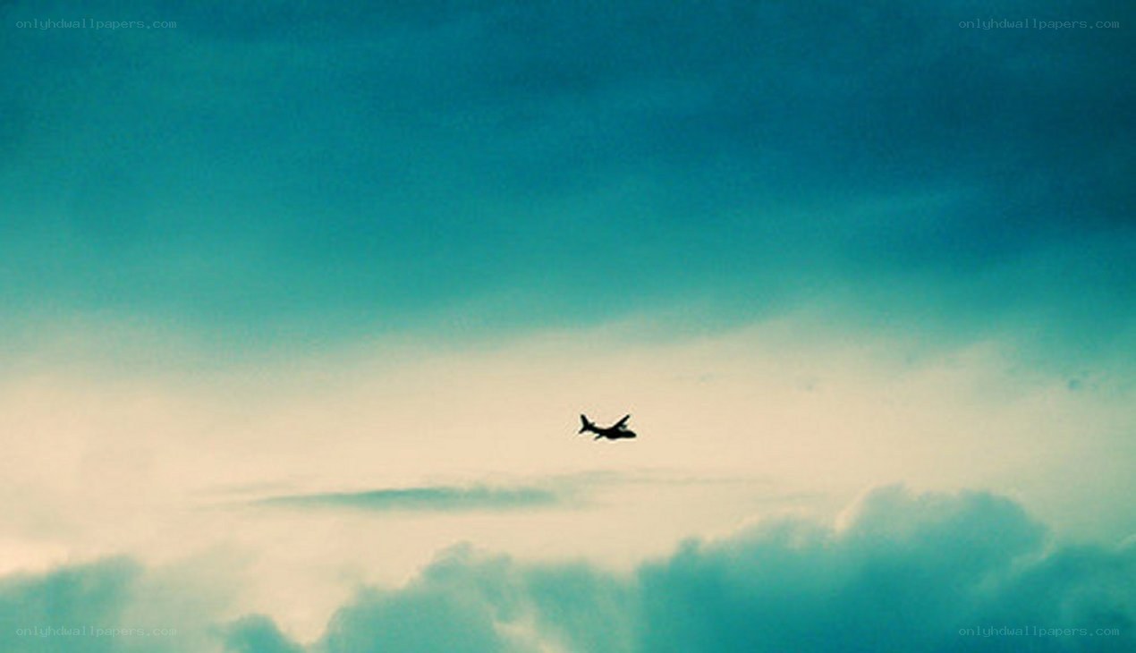 Airplane flying through cloudy sky