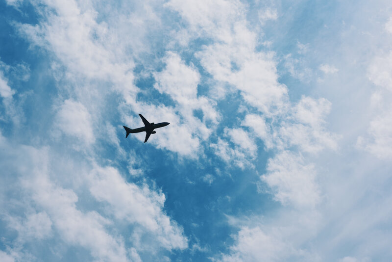 Airplane flying through cloudy sky