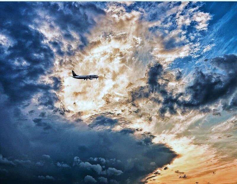 Airplane flying through dramatic clouds