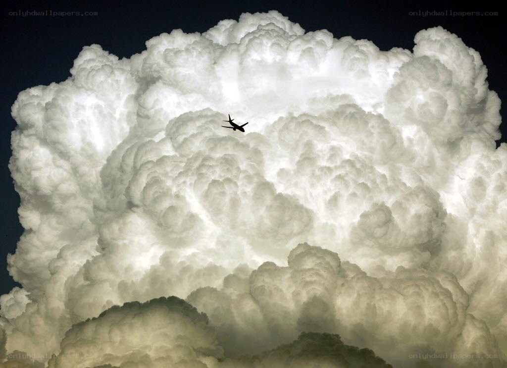 Airplane flying through storm cloud