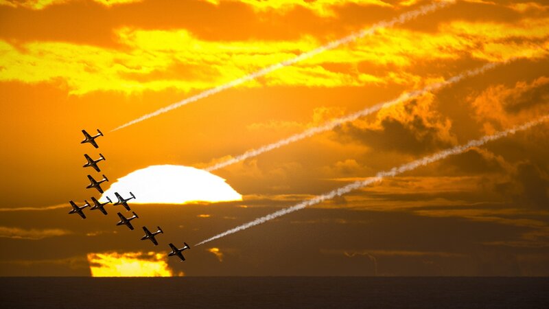 Airplane formation at sunset