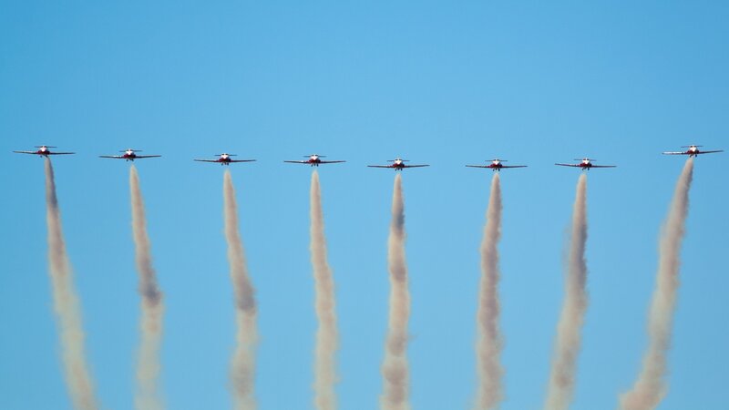 airplane formation with smoke trails