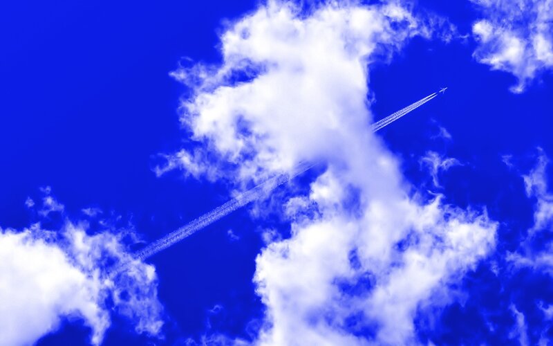 Airplane in Blue Sky — Dramatic, Photograph