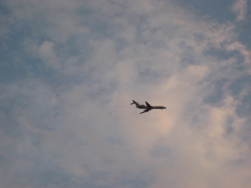 Airplane in Cloudy Sky — Blue, Calm