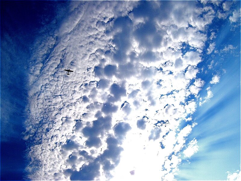Airplane in Cloudy Sky — Blue, Dramatic, Afternoon, Photograph, Clouds, Sunlight