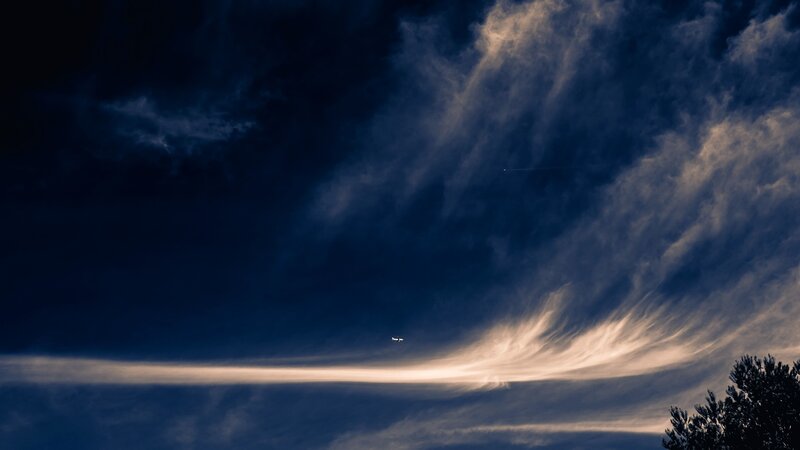 Airplane in Cloudy Sky — Blue, Dramatic, Night