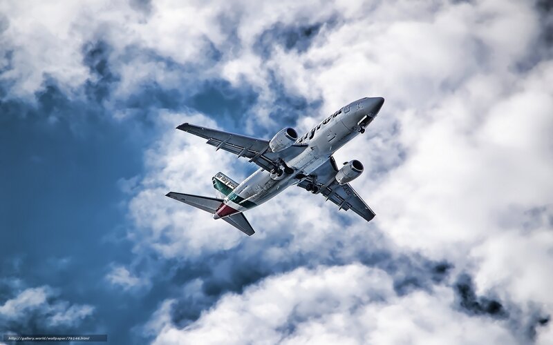 Airplane in Cloudy Sky — Blue, Dramatic