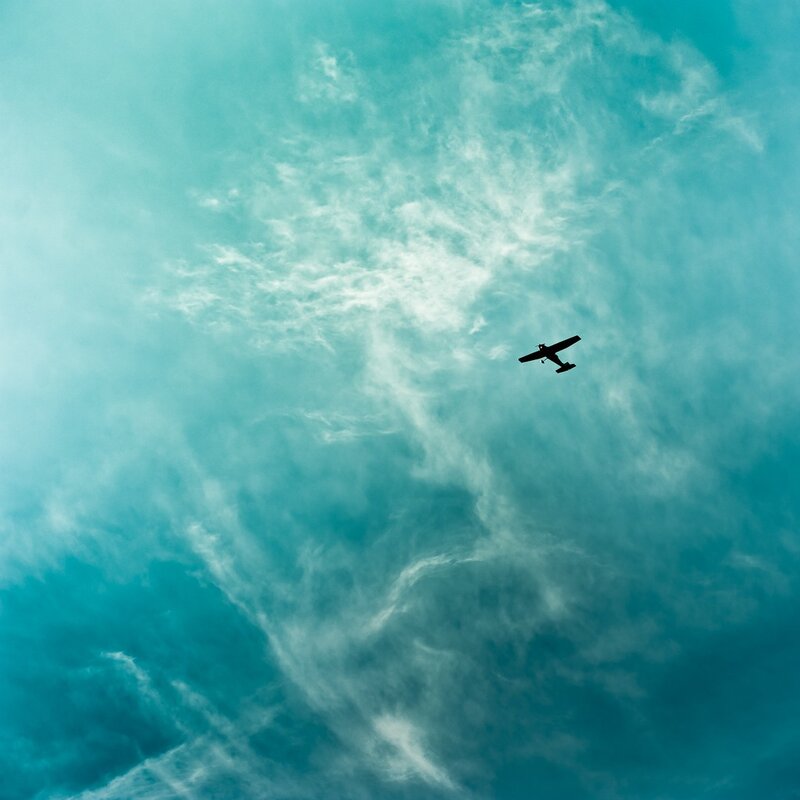 Airplane in Cloudy Sky — Blue, Serene, Photograph, Clouds