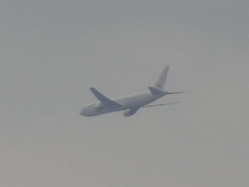 Airplane in Cloudy Sky — Gray, Overcast