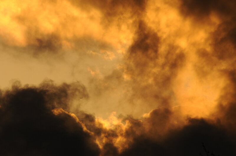 Airplane in Cloudy Sky — Orange, Dramatic