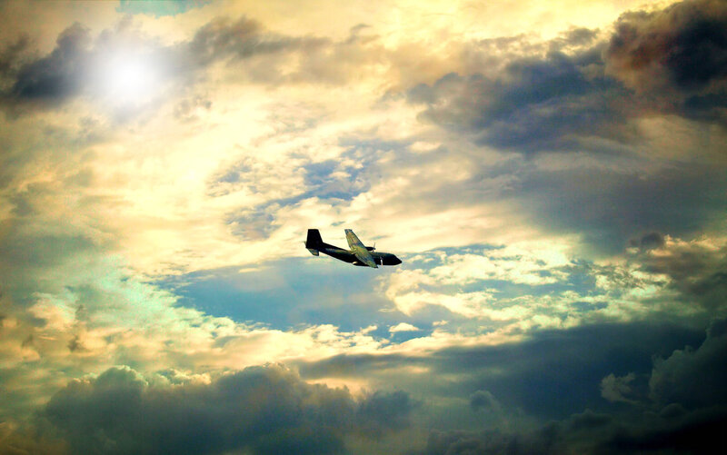 Airplane in Cloudy Sky — Yellow