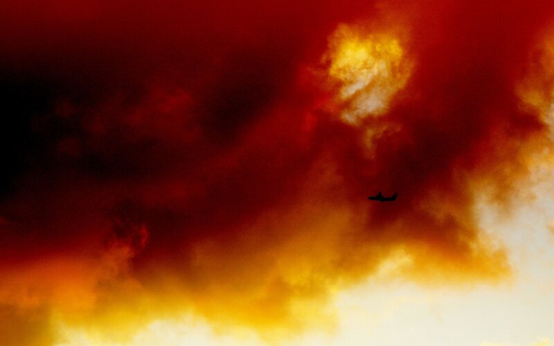 Airplane in Fiery Sky