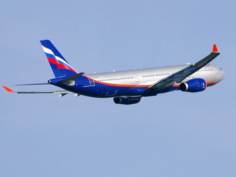 Airplane in flight against blue sky