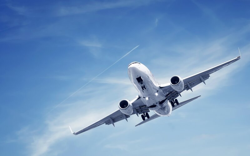 Airplane in flight against blue sky