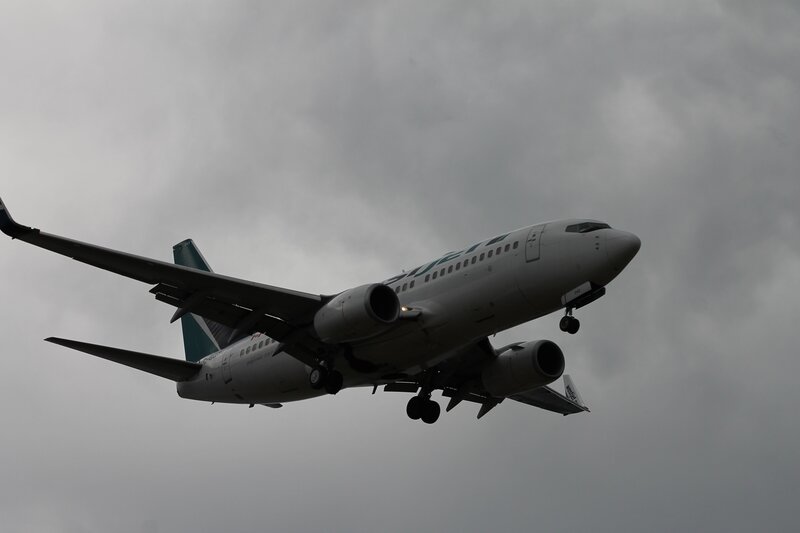 Airplane in flight against cloudy sky