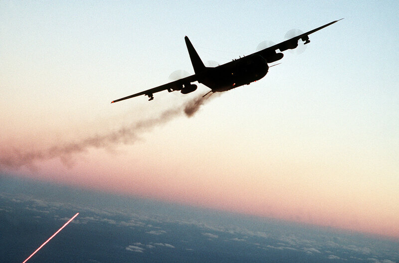 Airplane in flight at sunset