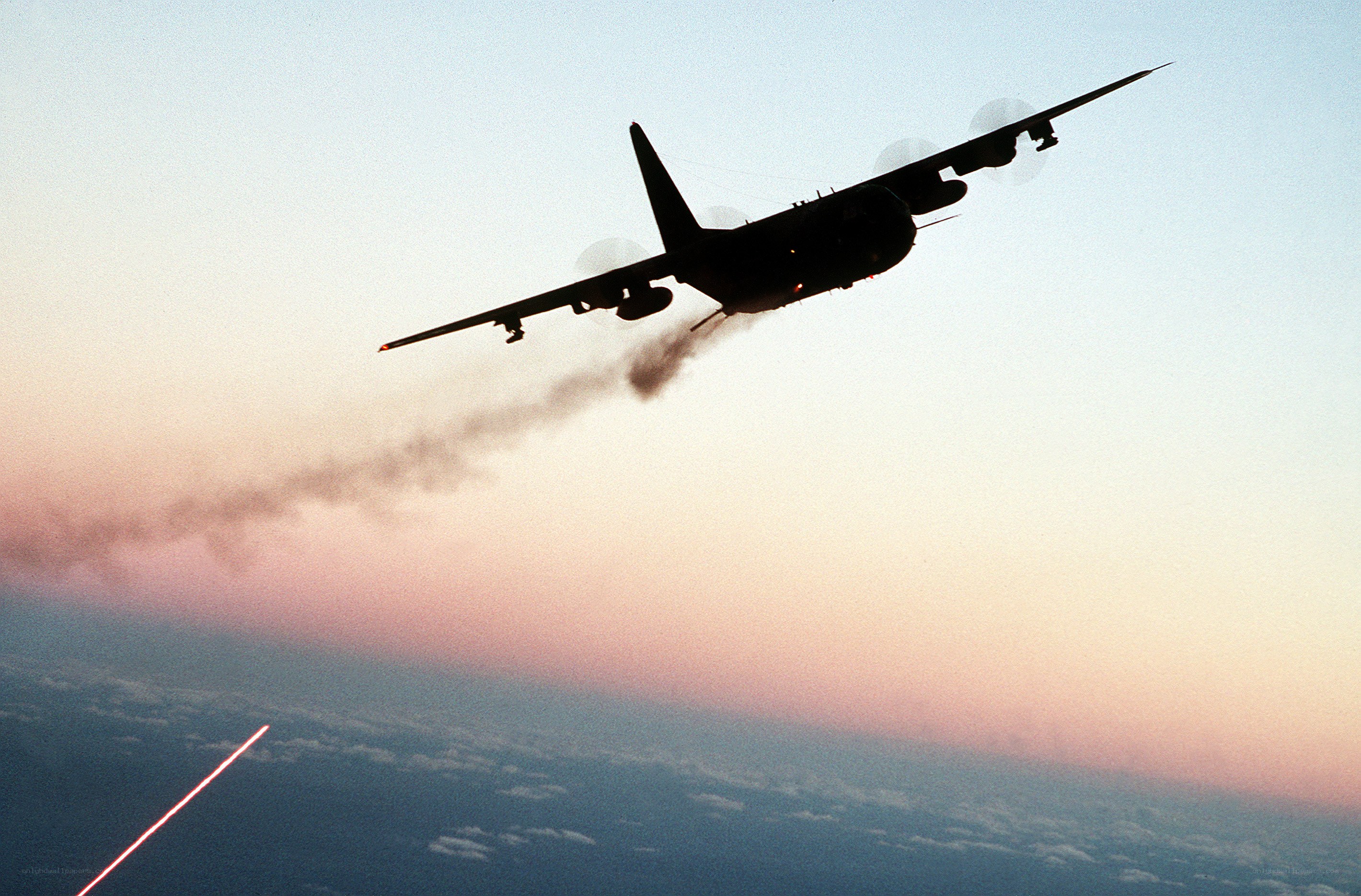 Airplane in flight at sunset