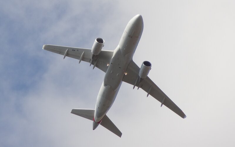 Airplane in Flight — Gray, Calm, Afternoon